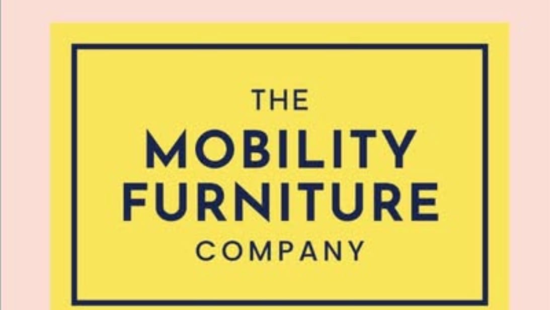 A yellow sign on a pink background with the words Mobility Furniture Company