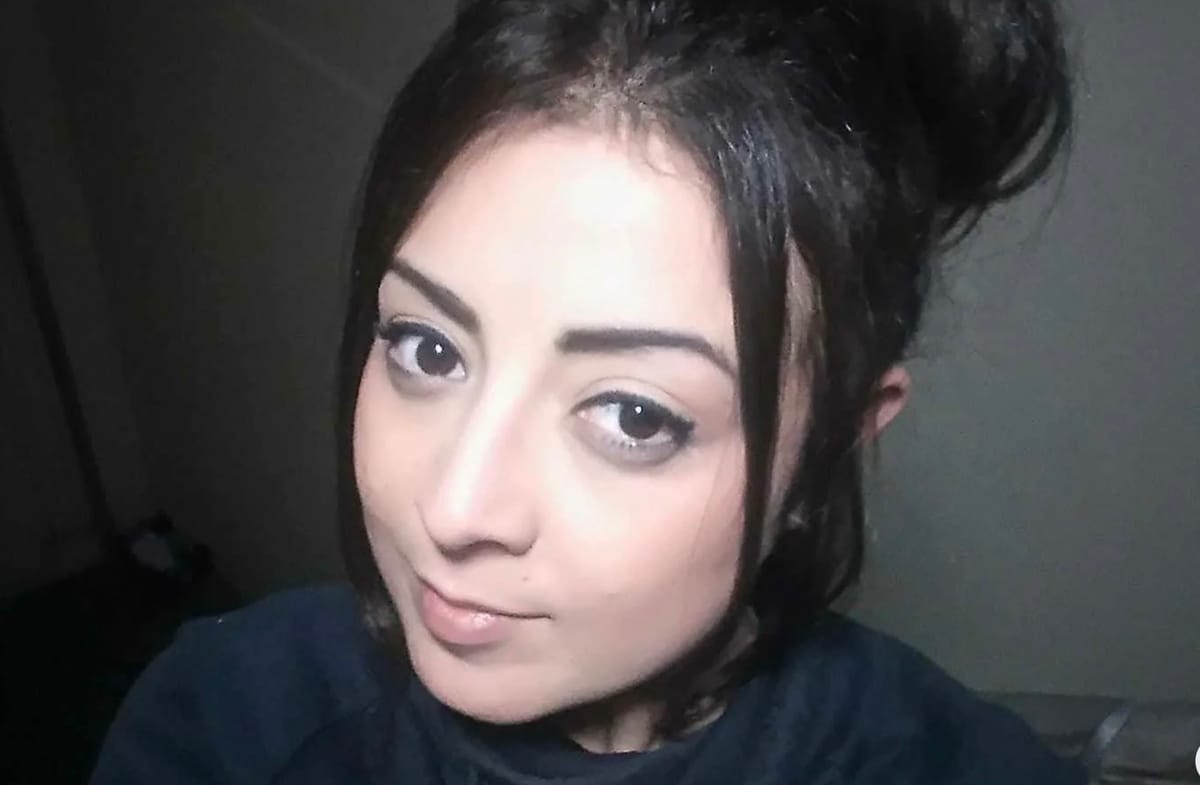 A picture of a woman Georgina Gharsellah dressed in dark clothing looking at the camera 