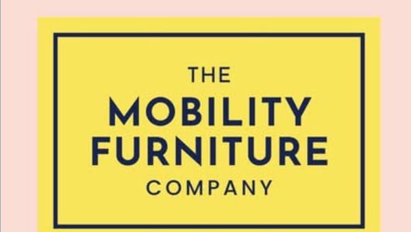 A yellow sign on a pink background with the words Mobility Furniture Company