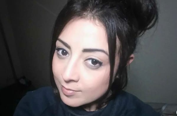 A picture of a woman Georgina Gharsellah dressed in dark clothing looking at the camera 